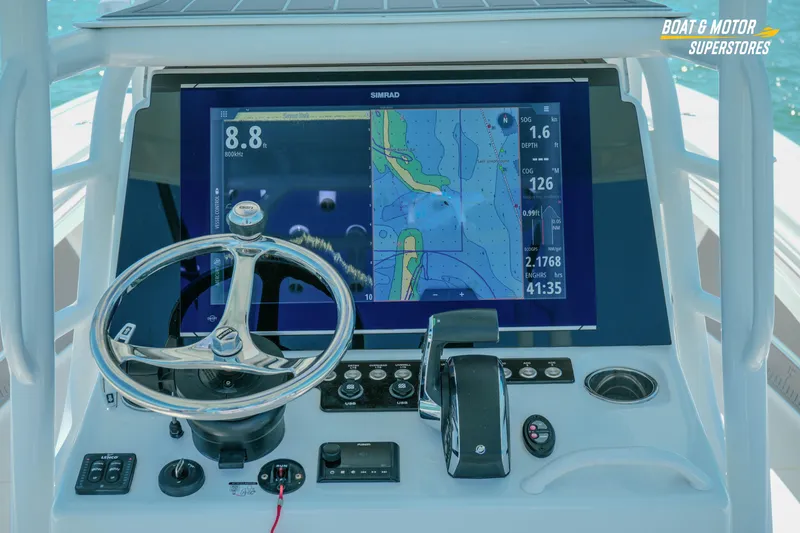Slide: The Image of Helm of 2018 Barker Boatworks 26 Open with navigation display and controls. - 70