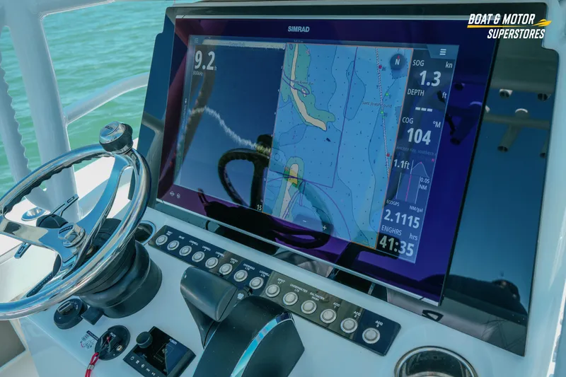 Slide: The Image of 2018 Barker Boatworks 26 Open dashboard with navigation display and steering wheel. - 74