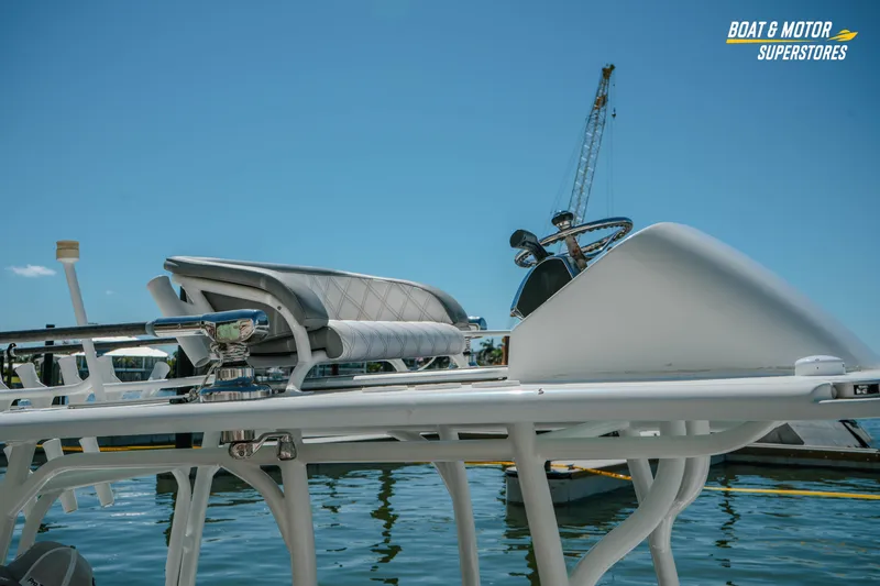 Slide: The Image of 2018 Barker Boatworks 26 Open, sleek design, docked under clear blue sky. - 78