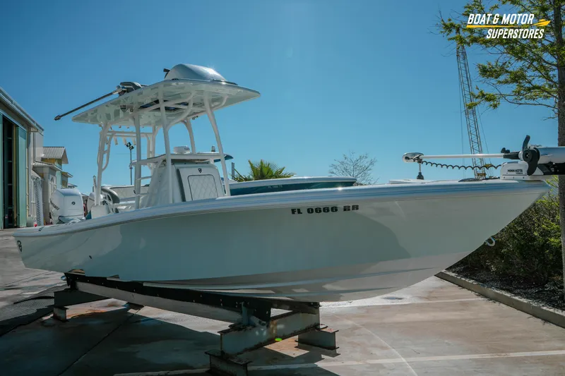 Slide: The Image of 2018 Barker Boatworks 26 Open on display at Boat & Motor Superstores under clear blue sky. - 8