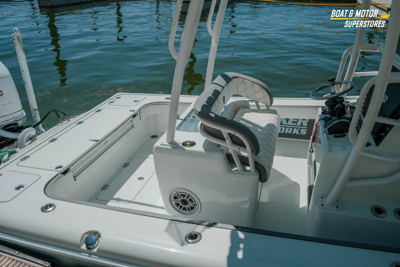 Slide: The Image of 2018 Barker Boatworks 26 Open, featuring a sleek cockpit and comfortable seating by the water. - 81