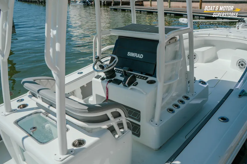 Slide: The Image of 2018 Barker Boatworks 26 Open helm with Simrad electronics, docked by the water. - 82