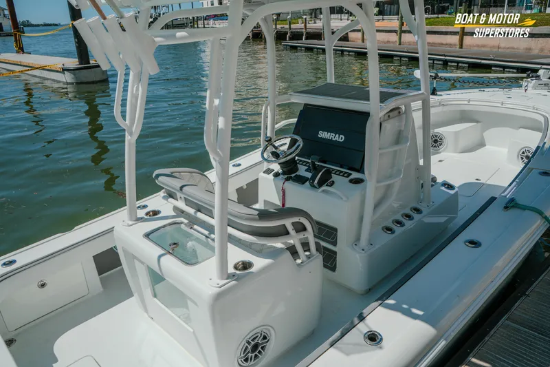 Slide: The Image of 2018 Barker Boatworks 26 Open at dock, featuring helm and seating area. - 83