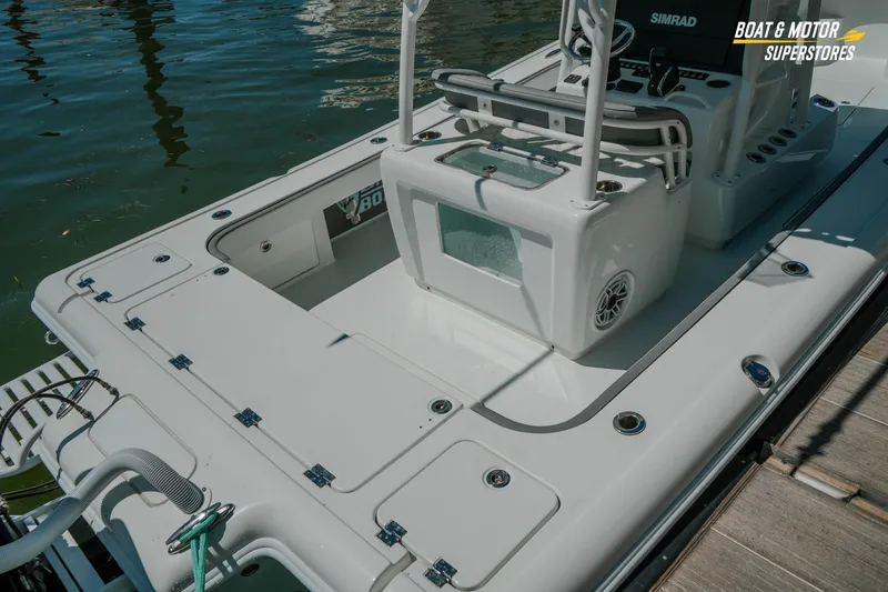 Slide: The Image of 2018 Barker Boatworks 26 Open docked, showcasing spacious deck and modern equipment. - 85