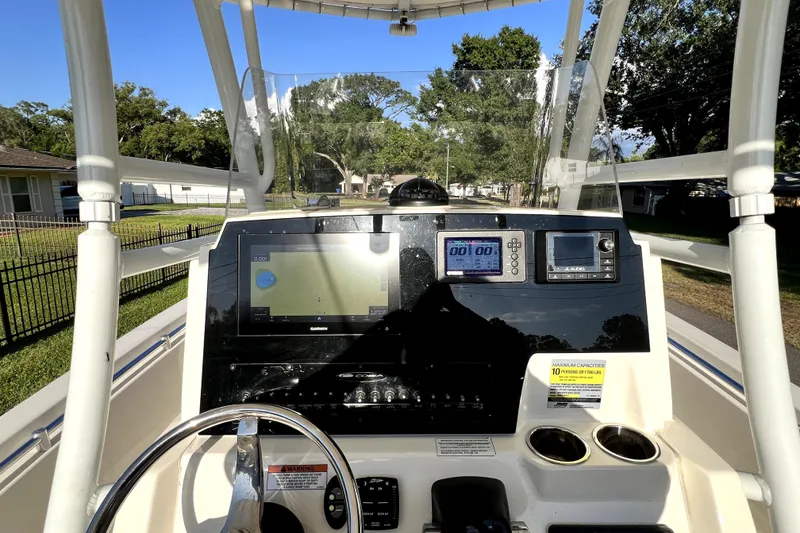 Slide: The Image of 2021 Cobia 240 Center Console boat dashboard with navigation and control systems. - 101