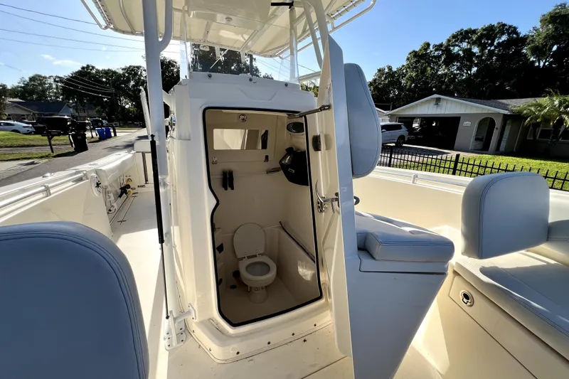 Slide: The Image of 2021 Cobia 240 Center Console boat with open cabin and visible toilet. - 108