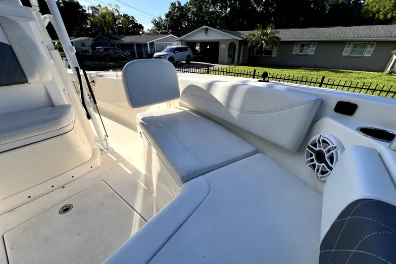 Slide: The Image of 2021 Cobia 240 Center Console boat interior with cushioned seating and speaker. - 114