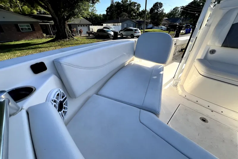 Slide: The Image of 2021 Cobia 240 Center Console boat interior with white seating and speaker. - 115
