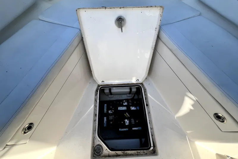 Slide: The Image of Open hatch on 2021 Cobia 240 Center Console boat, revealing storage compartment. - 122