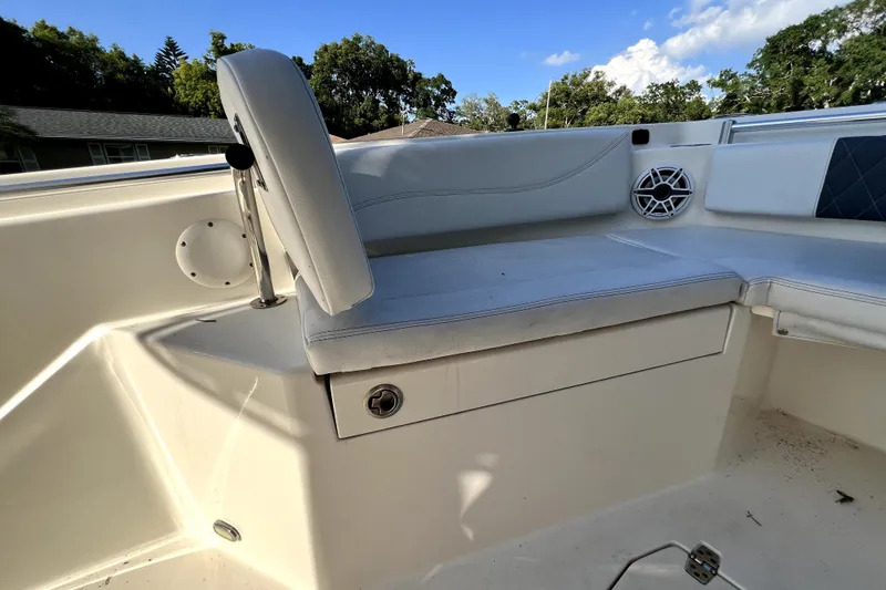 Slide: The Image of 2021 Cobia 240 Center Console boat interior with cushioned seating and speaker. - 127