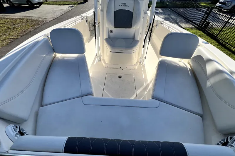 Slide: The Image of 2021 Cobia 240 Center Console boat interior with cushioned seating and console view. - 128