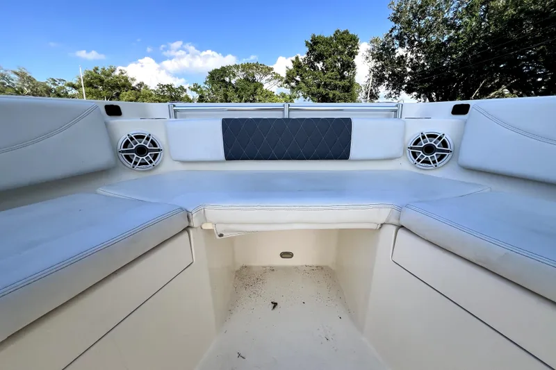 Slide: The Image of 2021 Cobia 240 Center Console boat interior with cushioned seating and speakers. - 129