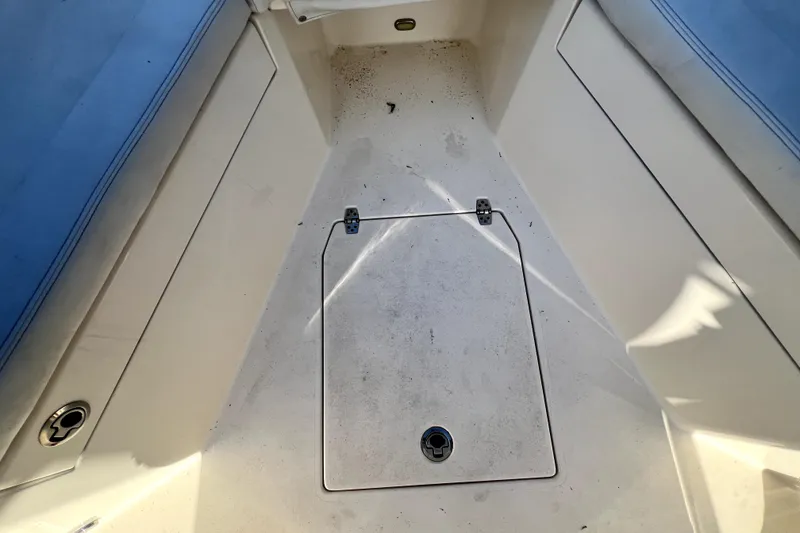 Slide: The Image of 2021 Cobia 240 Center Console boat deck with storage hatch and seating. - 133