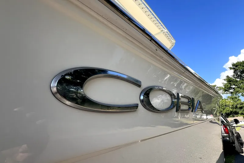Slide: The Image of 2021 Cobia 240 Center Console boat with logo, clear blue sky background. - 17