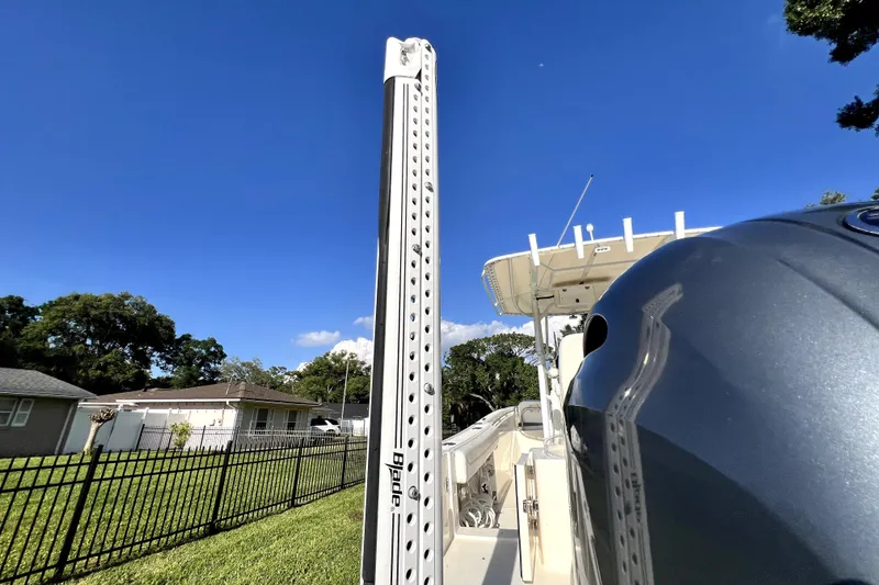 Slide: The Image of 2021 Cobia 240 Center Console boat with Power-Pole, parked in a residential area. - 20