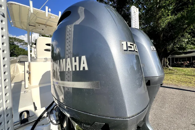 Slide: The Image of 2021 Cobia 240 Center Console with dual Yamaha 150 outboard engines. - 22