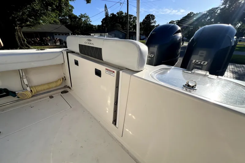 Slide: The Image of 2021 Cobia 240 Center Console boat interior with Yamaha engines and storage compartments. - 40