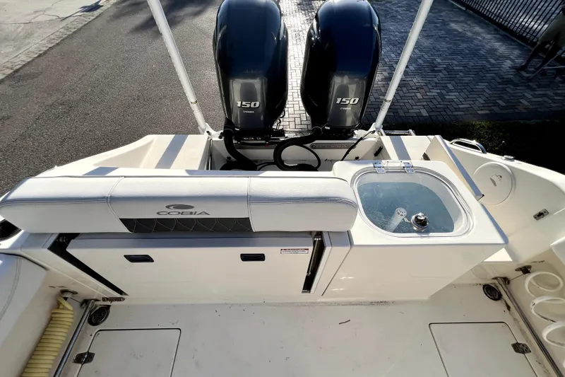 Slide: The Image of 2021 Cobia 240 Center Console boat with dual Yamaha 150 engines and livewell. - 41