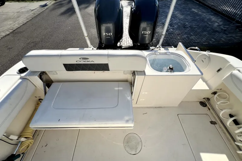 Slide: The Image of 2021 Cobia 240 Center Console boat interior with dual Yamaha 150 engines. - 42