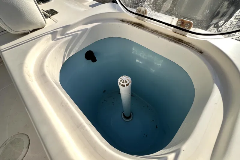 Slide: The Image of Livewell on 2021 Cobia 240 Center Console boat, featuring a clean, blue interior. - 45