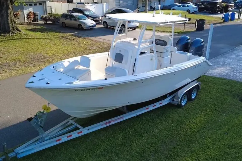 Slide: The Image of 2021 Cobia 240 Center Console boat on trailer, parked in residential area. - 5