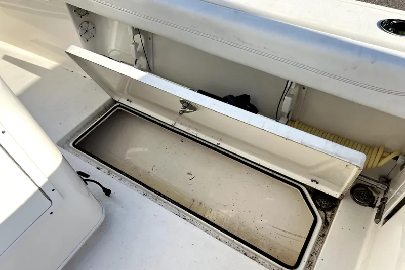 Slide: The Image of Open storage compartment on 2021 Cobia 240 Center Console boat deck. - 53