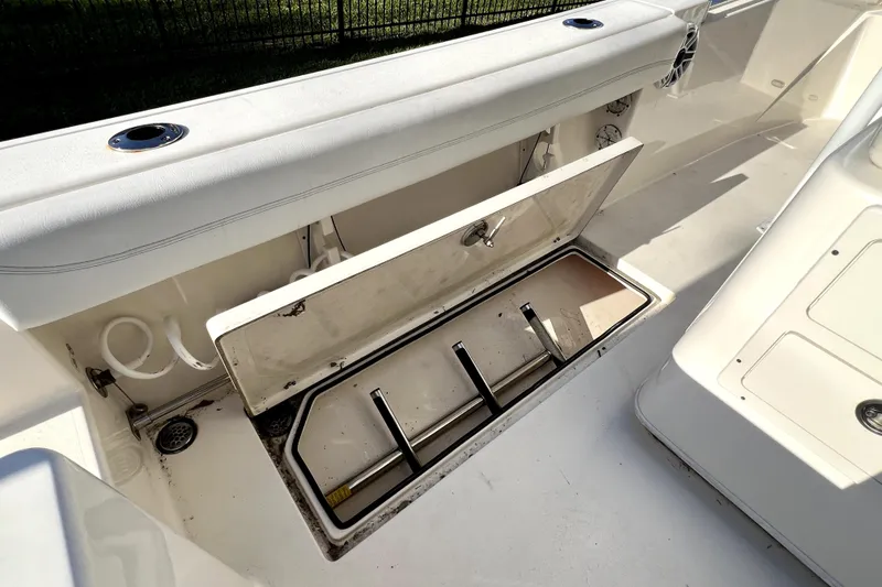 Slide: The Image of Open storage compartment on 2021 Cobia 240 Center Console boat deck. - 54