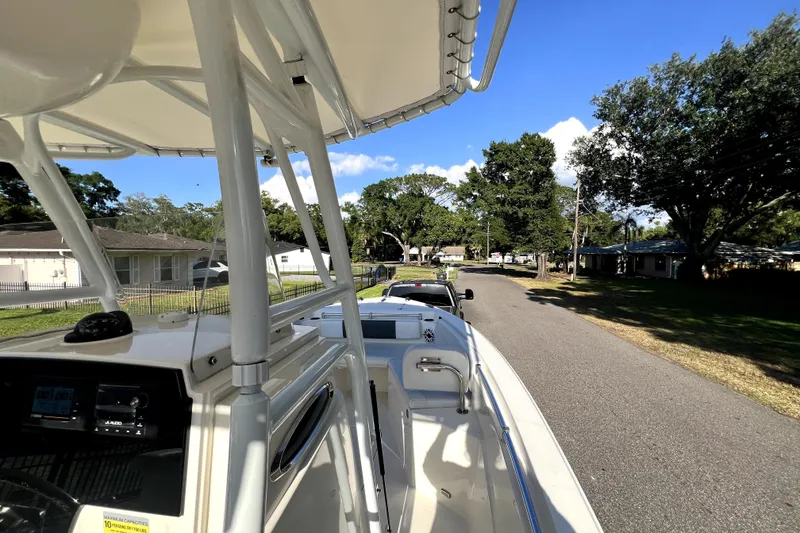 Slide: The Image of 2021 Cobia 240 Center Console boat on trailer, parked on suburban street. - 55