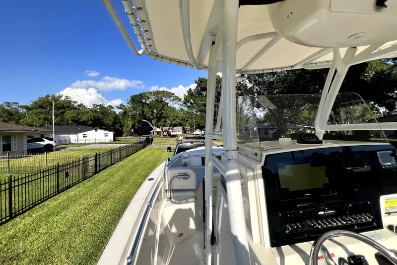 Slide: The Image of 2021 Cobia 240 Center Console boat parked on grassy lawn, sunny day. - 56