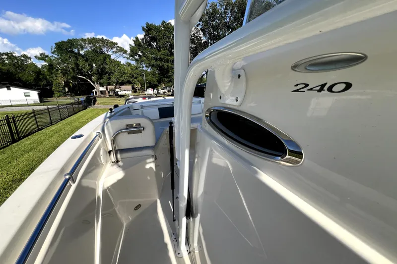 Slide: The Image of 2021 Cobia 240 Center Console boat, side view, showcasing sleek design and chrome details. - 57