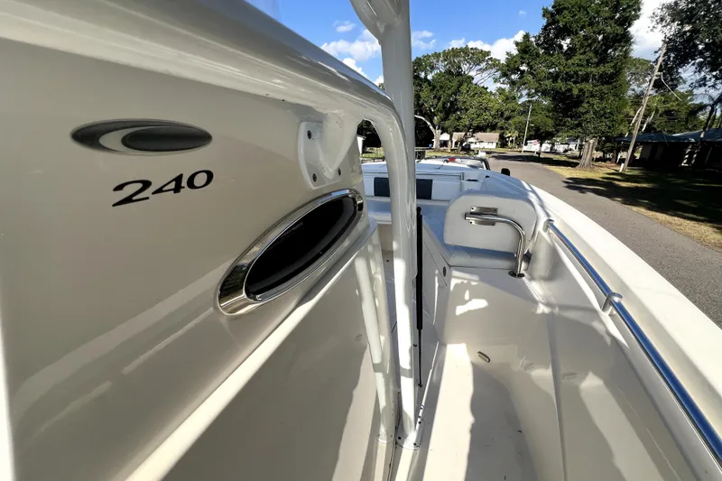 Slide: The Image of 2021 Cobia 240 Center Console boat, side view with seating and railing, outdoors. - 58