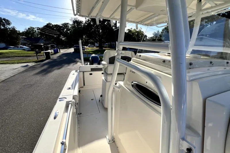 Slide: The Image of 2021 Cobia 240 Center Console boat parked on a residential street. - 63