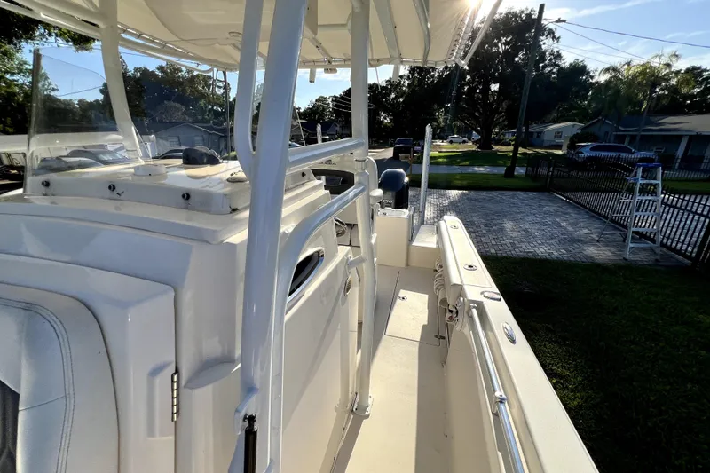 Slide: The Image of 2021 Cobia 240 Center Console boat parked in a residential driveway. - 64