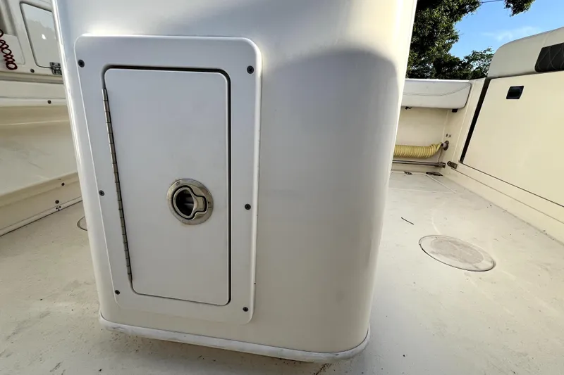 Slide: The Image of 2021 Cobia 240 Center Console boat interior with storage compartment and seating area. - 66