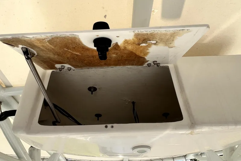 Slide: The Image of Open storage compartment on a 2021 Cobia 240 Center Console boat. - 69