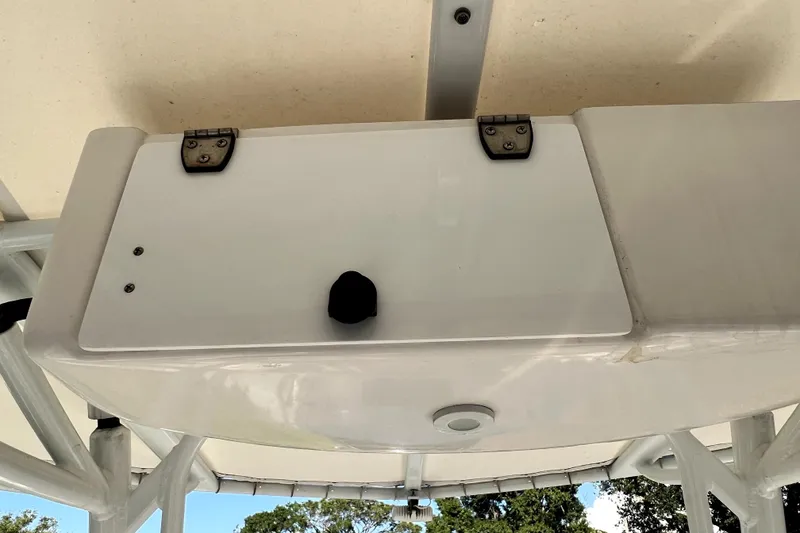 Slide: The Image of 2021 Cobia 240 Center Console boat's overhead compartment with hinges and latch. - 70
