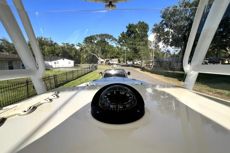 Slide: The Image of 2021 Cobia 240 Center Console boat being towed on a sunny residential street. - 71