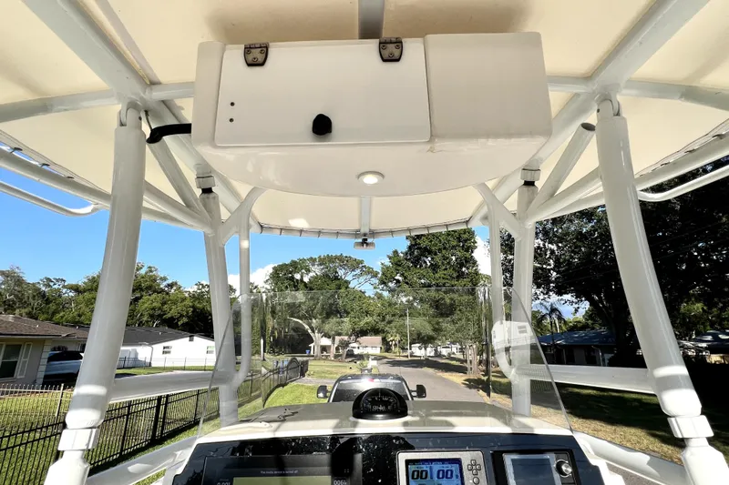 Slide: The Image of 2021 Cobia 240 Center Console boat interior with T-top and control panel. - 77