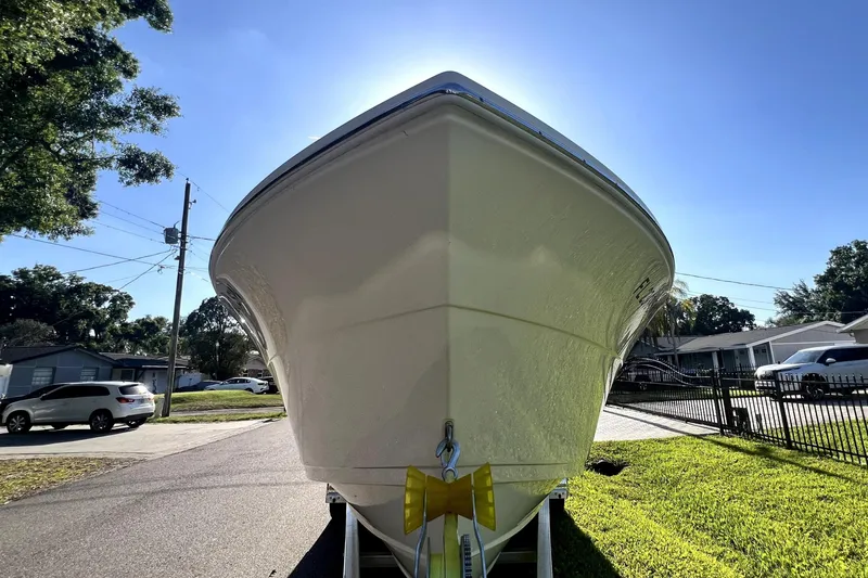Slide: The Image of 2021 Cobia 240 Center Console boat on trailer, sunny day, residential neighborhood. - 8
