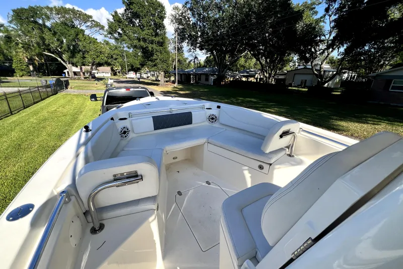 Slide: The Image of 2021 Cobia 240 Center Console boat with spacious seating, parked on a grassy lawn. - 88