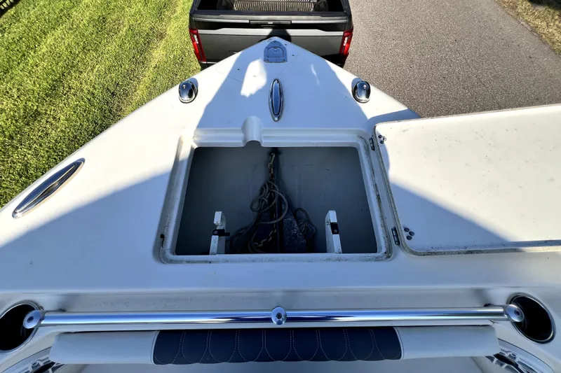Slide: The Image of 2021 Cobia 240 Center Console boat with open anchor locker, viewed from above. - 90