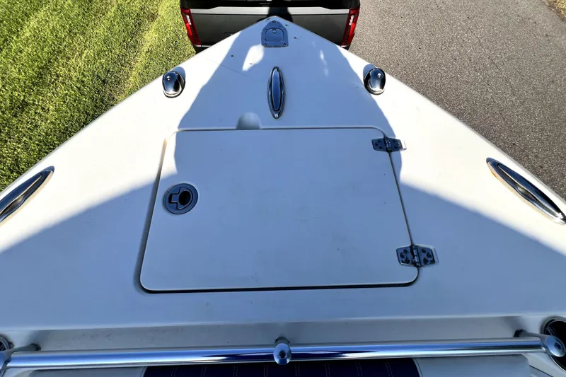 Slide: The Image of Bow view of 2021 Cobia 240 Center Console boat, featuring storage hatch and cleats. - 91