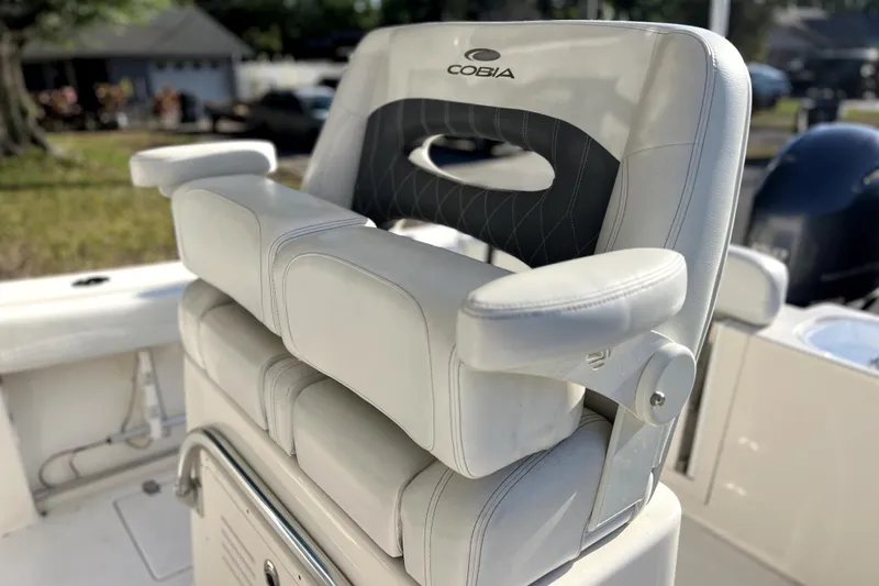 Slide: The Image of 2021 Cobia 240 Center Console boat seat with armrests and logo. - 96