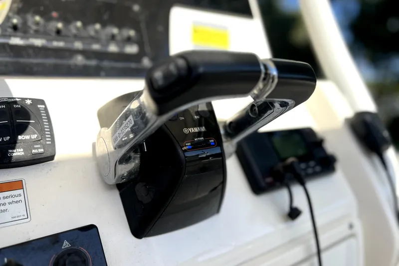 Slide: The Image of Close-up of 2021 Cobia 240 Center Console boat controls and throttle. - 97