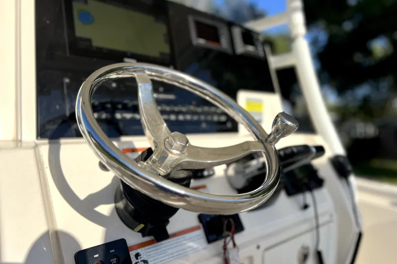 Slide: The Image of Steering wheel of a 2021 Cobia 240 Center Console boat, close-up view. - 98