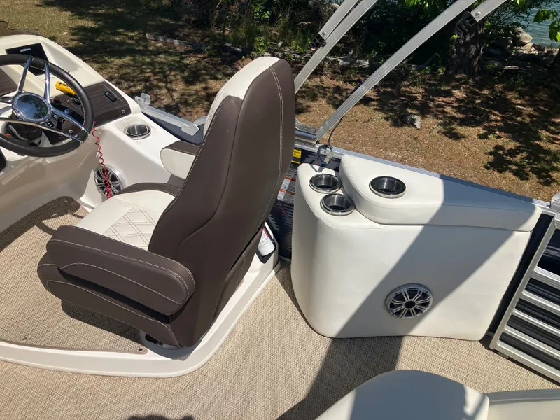 Slide: The Image of Interior of a 2019 Bennington 23 QLC boat with steering wheel and seat. - 11