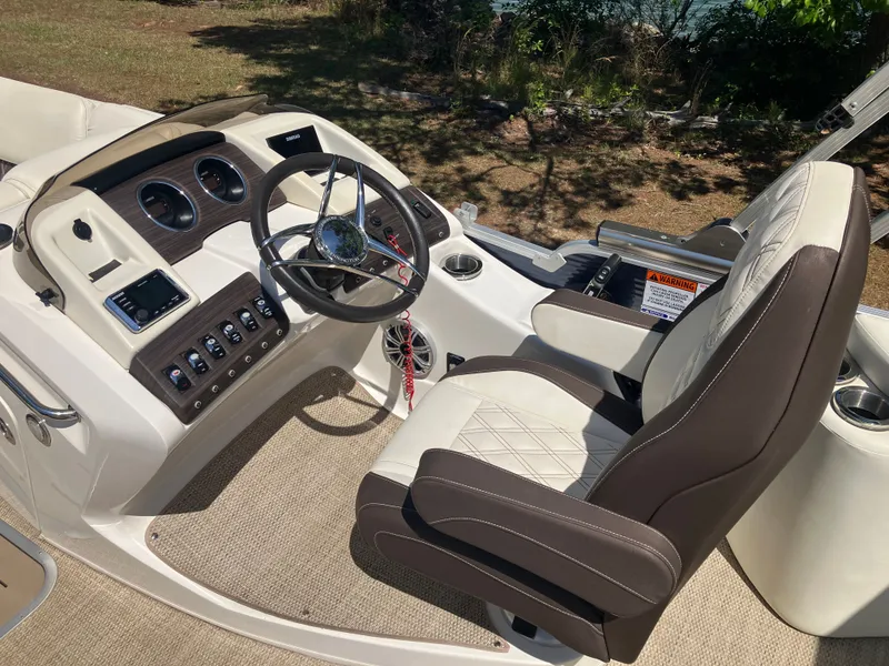 Slide: The Image of Interior of a 2019 Bennington 23 QLC boat with steering console. - 12
