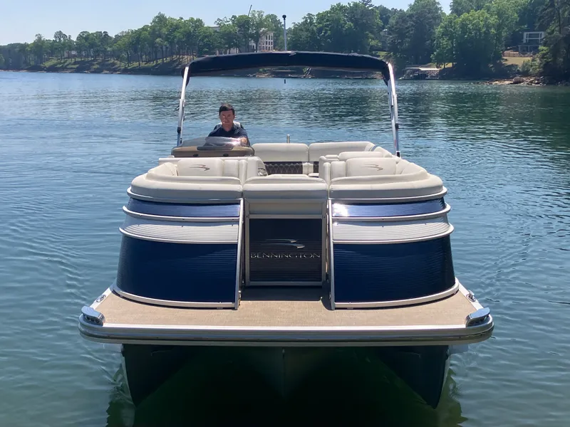 Slide: The Image of 2019 Bennington 23 QLC pontoon boat on calm water. - 2