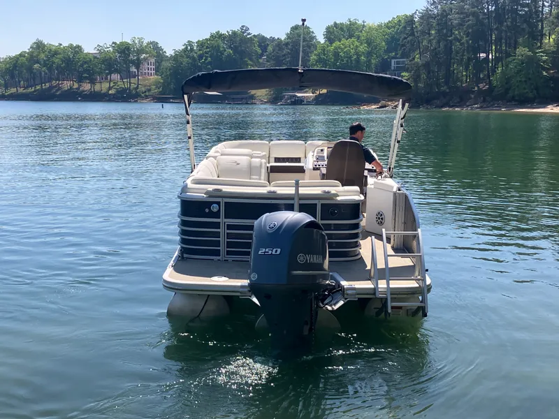 Slide: The Image of Bennington 23 QLC 2019 pontoon boat on a serene lake. - 6