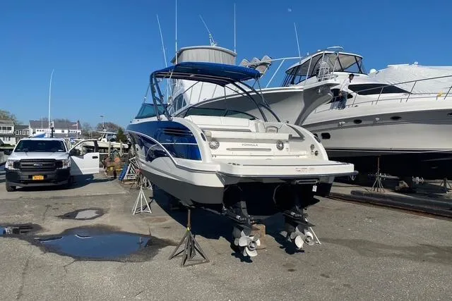 Slide: The Image of 2016 Formula 290 Bowrider boat on stands in a marina, surrounded by other vessels. - 11